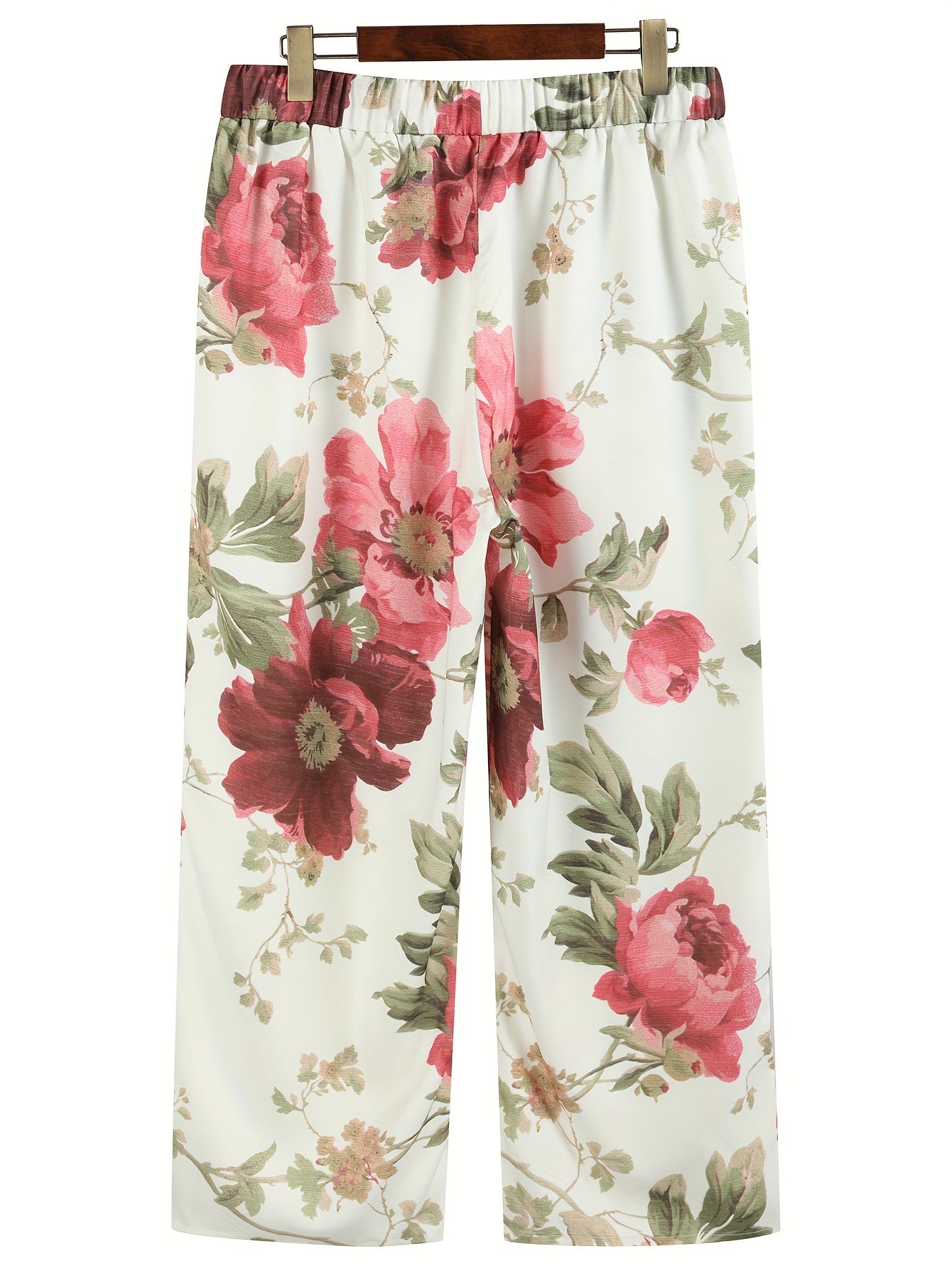 Pantalon ample à motifs floraux rouges et verts sur fond blanc, style décontracté, idéal pour l'été. Mode féminine, tendance et confortable.