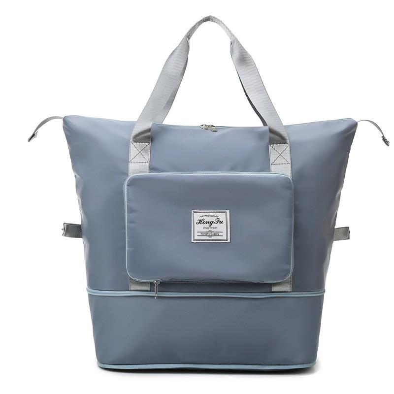 Sac à dos gris élégant avec poche avant zippée, poignées robustes et design moderne. Idéal pour le voyage, l'école ou le travail.