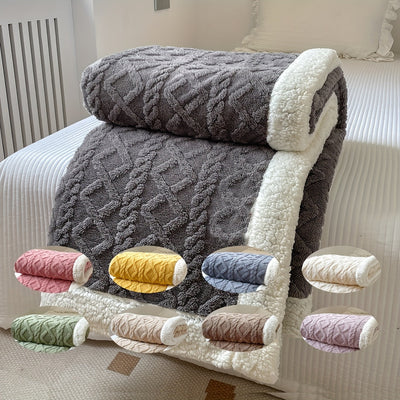 Plaid en laine gris avec bordure blanche sur un lit, neuf variantes de couleur en médaillon. Couverture chaude, design géométrique, décoration chambre.