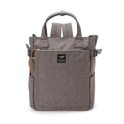 Sac à dos Anello gris en toile, design moderne avec poches multiples, fermeture éclair dorée, idéal pour voyage, école ou travail.