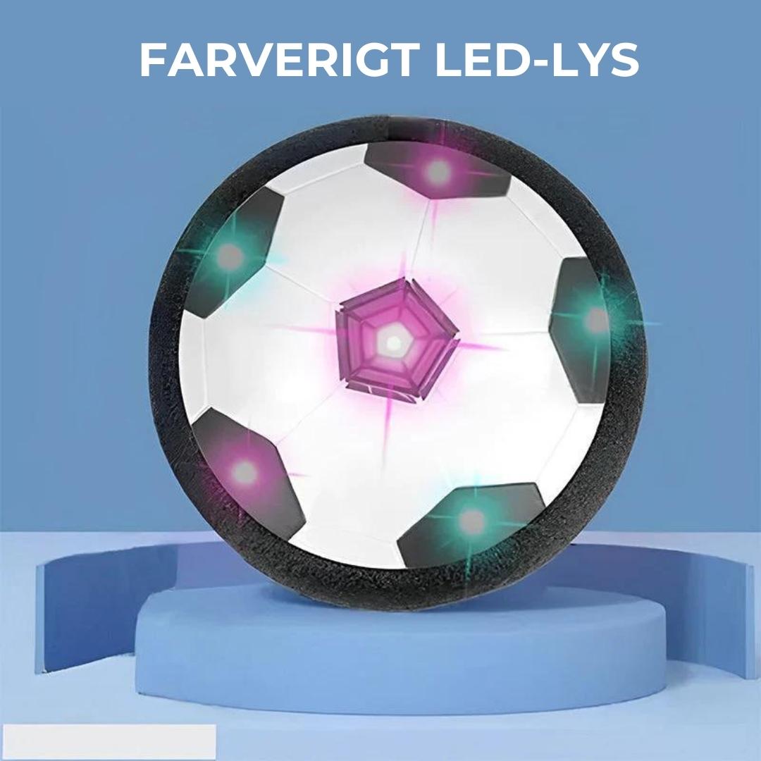 Ballon de football flottant avec lumières LED colorées, sur un socle bleu. Jouet interactif pour enfants, idéal pour jeux en intérieur.