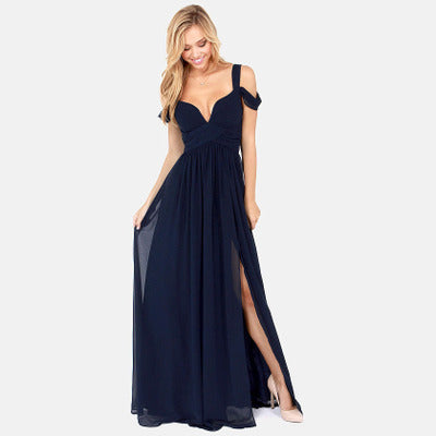 Robe de soirée longue bleu marine avec décolleté en cœur et fente latérale, portée par une femme blonde souriante. Mode élégante et chic.