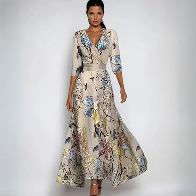 Robe longue élégante à motifs floraux, manches trois-quarts, fond beige, idéale pour soirées ou événements formels. Mode féminine chic.