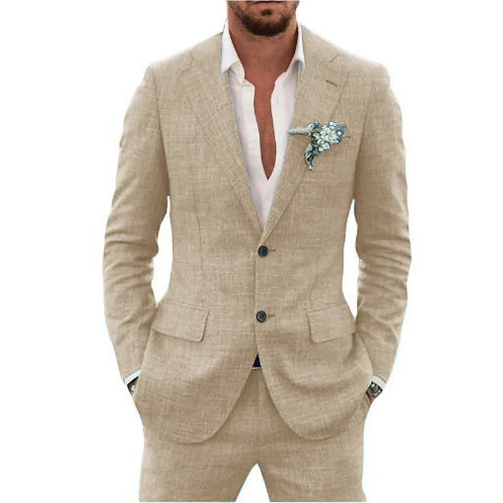 Homme en costume beige élégant, chemise blanche ouverte, pochette fleurie. Mode masculine, style chic, tenue formelle moderne.