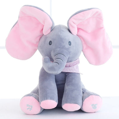 Peluche éléphant gris et rose avec grandes oreilles, écharpe à pois, assis sur fond blanc. Jouet doux pour enfants, cadeau idéal.