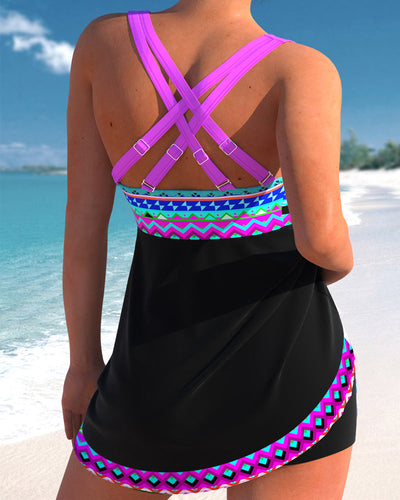 Femme en maillot de bain noir à motifs colorés, dos croisé, sur plage tropicale. Mode plage, vacances été, tenue bain élégante.