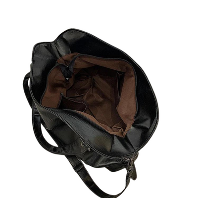 Sac à dos en cuir noir ouvert, intérieur marron, avec bretelles ajustables. Accessoire mode élégant et pratique pour le quotidien.