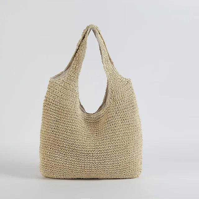 Sac cabas en paille tressée beige, design élégant et minimaliste, parfait pour l'été. Accessoire mode tendance, idéal pour la plage ou le shopping.