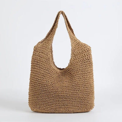 Sac cabas en paille tressée beige, design minimaliste, idéal pour l'été. Accessoire mode tendance, éco-responsable et pratique pour le quotidien.