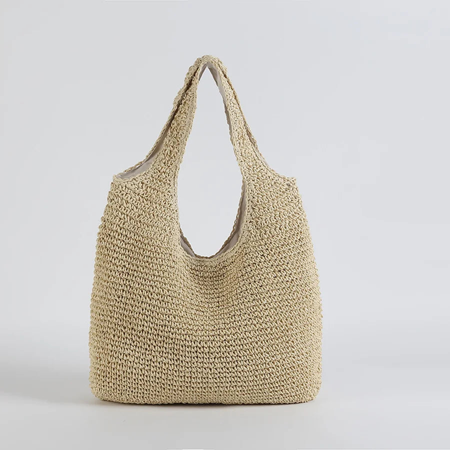 Sac cabas en paille tressée beige, design minimaliste, idéal pour l'été. Accessoire mode tendance, parfait pour la plage ou le shopping.
