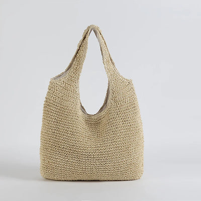 Sac cabas en paille tressée beige, design minimaliste, idéal pour l'été. Accessoire mode tendance, parfait pour la plage ou le shopping.