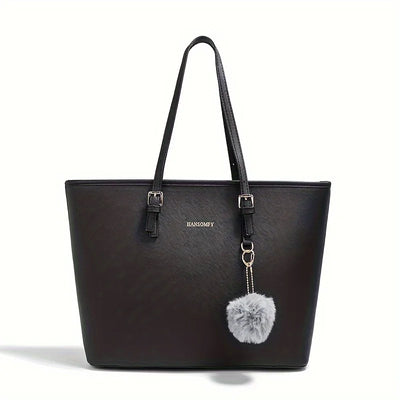 Sac à main noir élégant avec pompon gris, anses longues, design moderne. Accessoire mode femme, tendance et chic. Idéal pour toutes occasions.