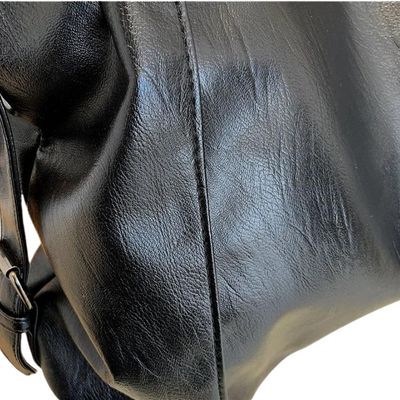 Sac à dos en cuir noir, texture lisse et brillante, avec sangle ajustable. Accessoire mode élégant et pratique pour le quotidien.