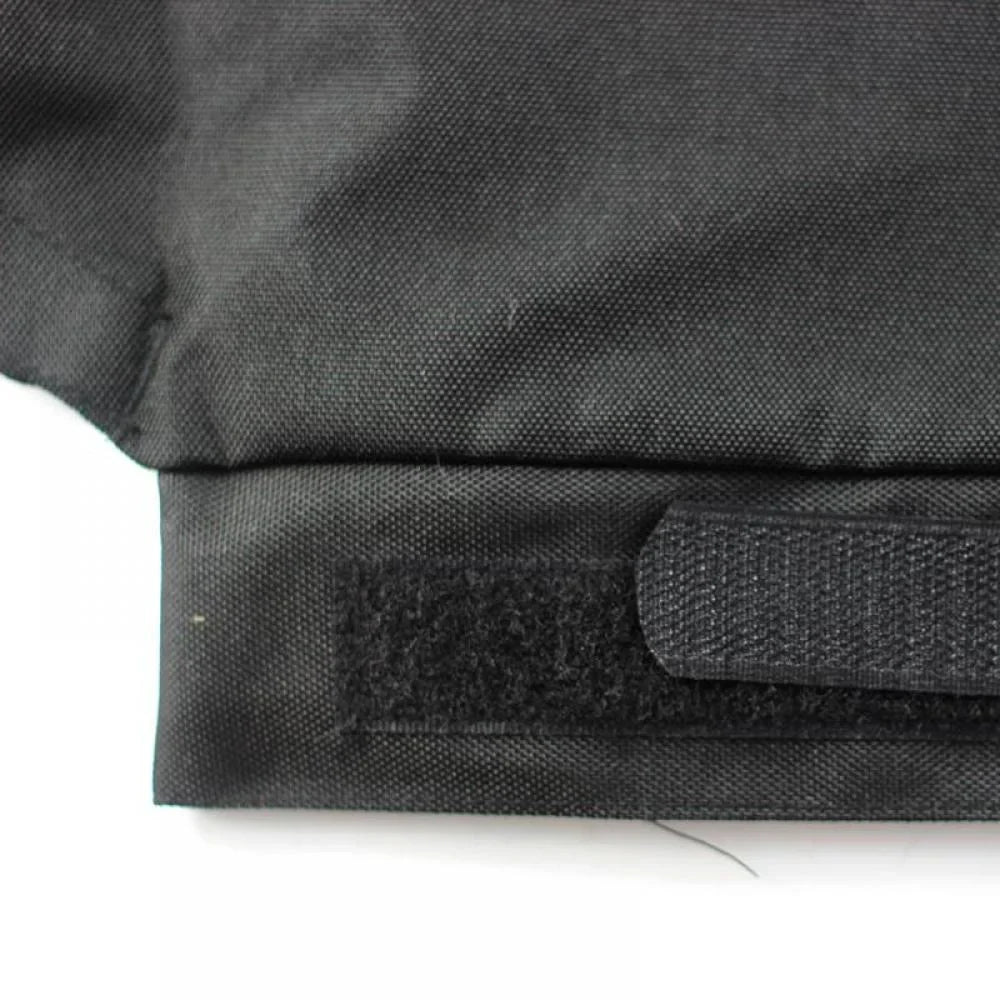 Gros plan sur un sac en tissu noir avec fermeture velcro, texture robuste. Accessoire de mode pratique, idéal pour le rangement sécurisé.