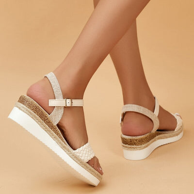 Sandales compensées blanches pour femme avec semelle en corde tressée, lanières ajustables, fond beige. Mode estivale, chaussures confortables.