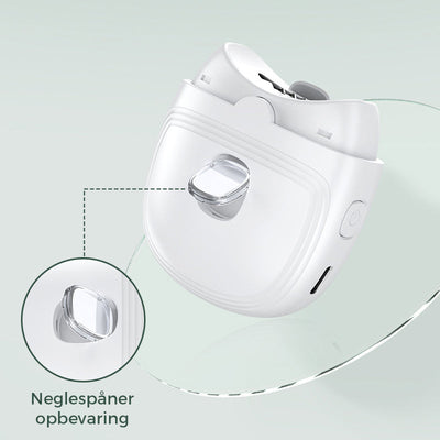 Taille-crayon à ongles blanc avec réservoir de stockage intégré, design moderne, bouton latéral, fond vert clair. Accessoire manucure innovant.