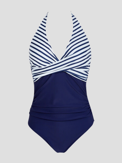 Maillot de bain une pièce bleu marine à rayures blanches, col en V, style croisé, élégant et moderne, idéal pour la plage et la piscine.