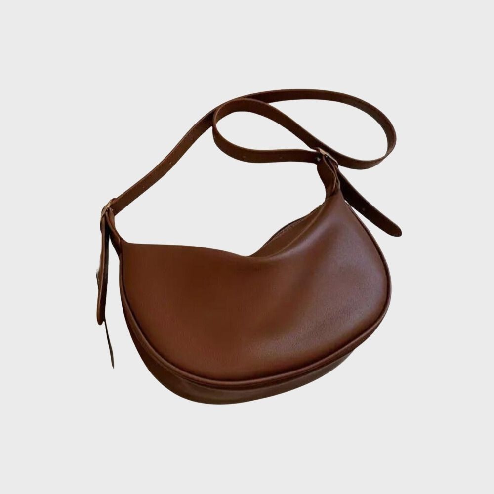 Sac à main en cuir marron, design demi-lune, bandoulière ajustable. Accessoire mode élégant et tendance pour femme.