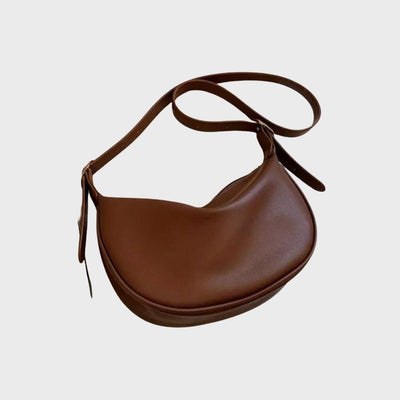 Sac à main en cuir marron, design demi-lune, bandoulière ajustable. Accessoire mode élégant et tendance pour femme.