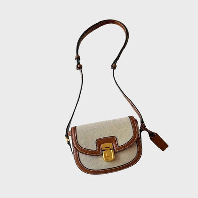 Sac à bandoulière en toile beige et cuir marron, boucle dorée, design élégant et moderne, accessoire de mode tendance pour femme.