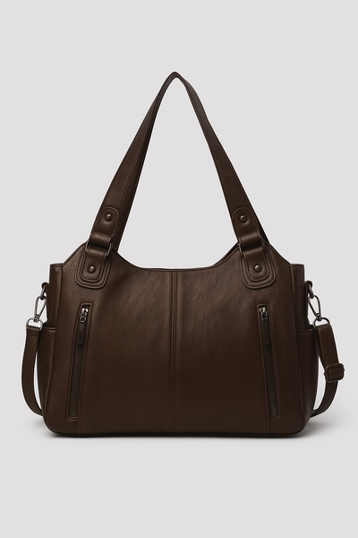 Sac à main en cuir marron avec bandoulière réglable, deux poches zippées à l'avant, design élégant et moderne, accessoire mode femme.
