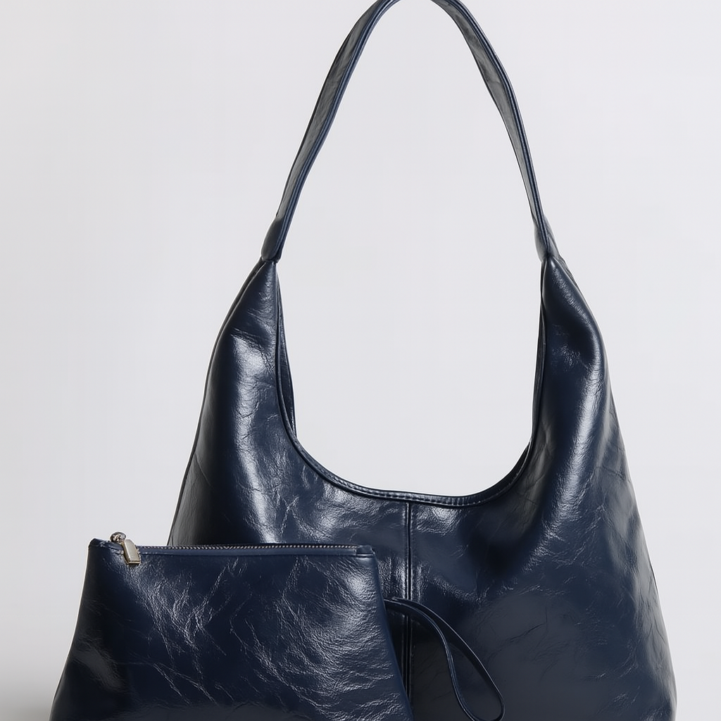 Sac à main en cuir bleu foncé avec pochette assortie, design élégant et moderne, parfait pour la mode féminine et les accessoires tendance.