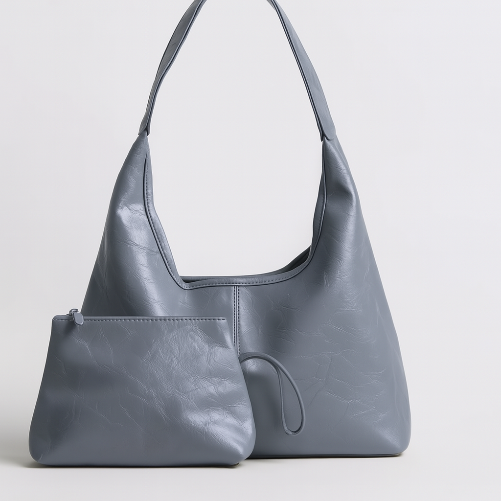 Sac à main en cuir bleu avec pochette assortie, design moderne et élégant, idéal pour la mode féminine. Accessoire tendance et pratique.