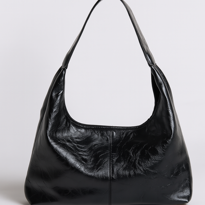 Sac à main noir en cuir élégant avec anse, design moderne et minimaliste, idéal pour la mode féminine et les accessoires tendance.