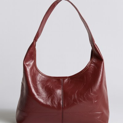 Sac à main en cuir rouge bordeaux, design moderne et élégant, avec une grande anse. Accessoire de mode tendance pour femmes.