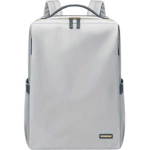Sac à dos gris moderne et minimaliste, avec fermeture éclair dorée, idéal pour le voyage et le quotidien. Design élégant et fonctionnel.