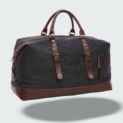 Sac de voyage en toile noire avec poignées en cuir marron, design élégant et spacieux, idéal pour les escapades et les voyages d'affaires.