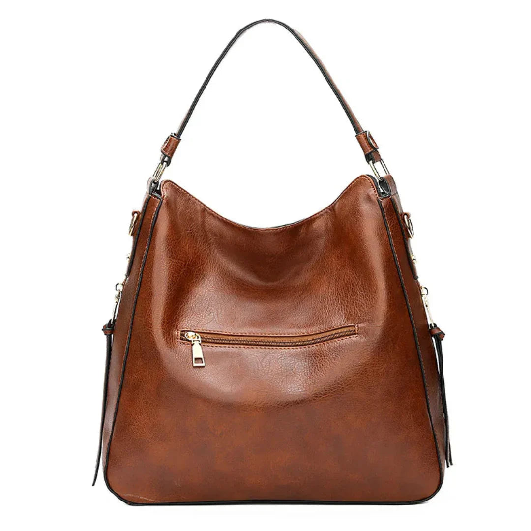 Sac à main en cuir marron avec bandoulière, poche zippée à l'avant. Élégant et spacieux, idéal pour un usage quotidien ou professionnel.