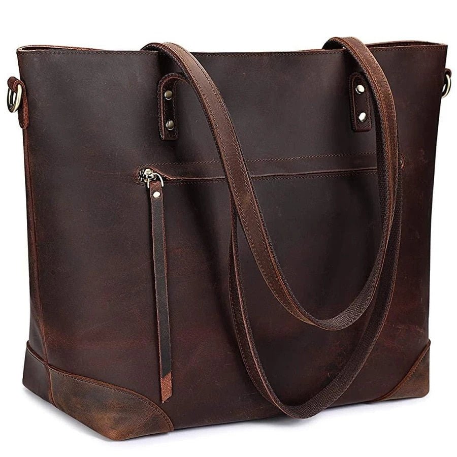 Sac à main en cuir marron foncé, style cabas, avec poignées longues et poche zippée extérieure. Accessoire mode élégant et pratique.