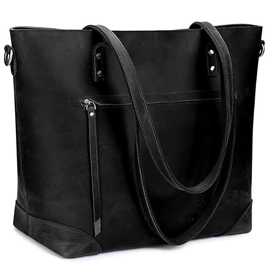 Sac à main en cuir noir élégant avec poignées longues, poche zippée avant. Accessoire mode femme, tendance et pratique pour le quotidien.