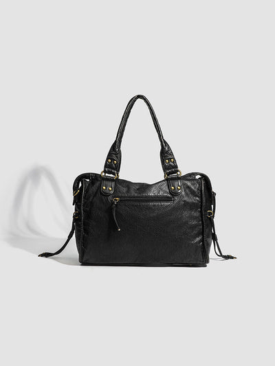 Sac à main en cuir noir élégant avec poignées doubles, détails dorés et poche zippée avant. Accessoire mode femme chic et tendance.