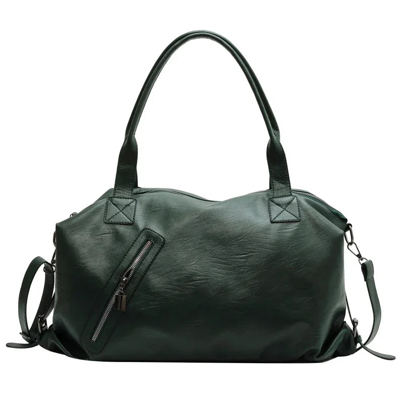 Sac à main en cuir vert foncé avec poignées doubles et bandoulière amovible, fermeture éclair frontale, design élégant et moderne.