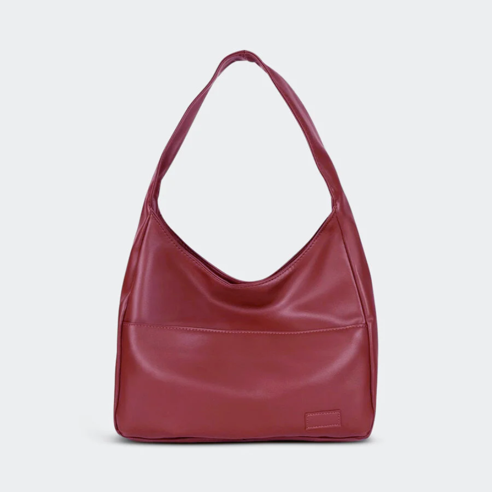 Sac à main en cuir rouge bordeaux, design moderne et minimaliste, avec une anse unique. Accessoire de mode élégant pour femmes.