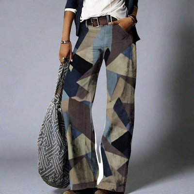 Pantalon large femme à motifs géométriques multicolores, style décontracté, avec sac à main texturé. Mode tendance, tenue chic et moderne.