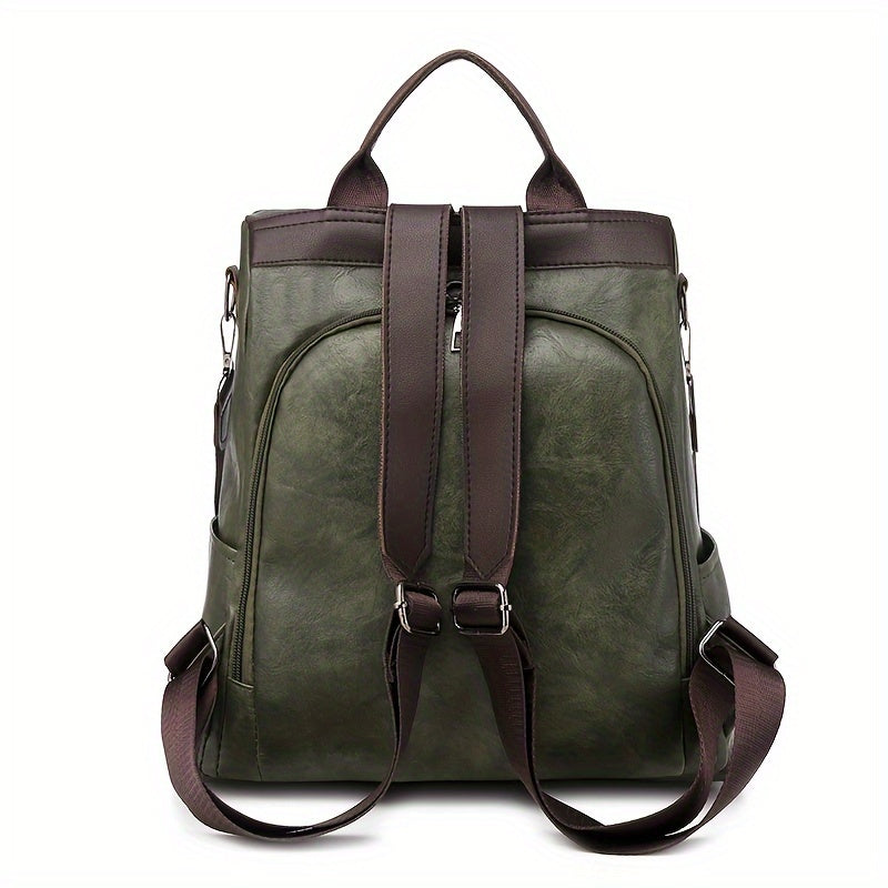 Sac à dos en cuir vert olive avec bretelles marron, design élégant et moderne, idéal pour le voyage ou l'usage quotidien.