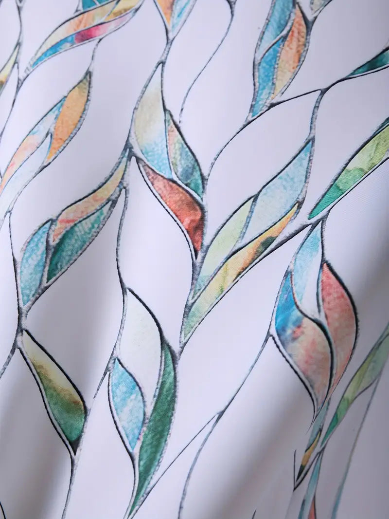 Motif abstrait coloré sur tissu blanc, avec des formes de feuilles en bleu, vert, orange et rose. Design artistique moderne, textile élégant.