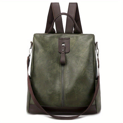 Sac à dos en cuir vert olive avec bretelles marron, fermeture éclair centrale et poignée supérieure. Design élégant et fonctionnel pour femmes.