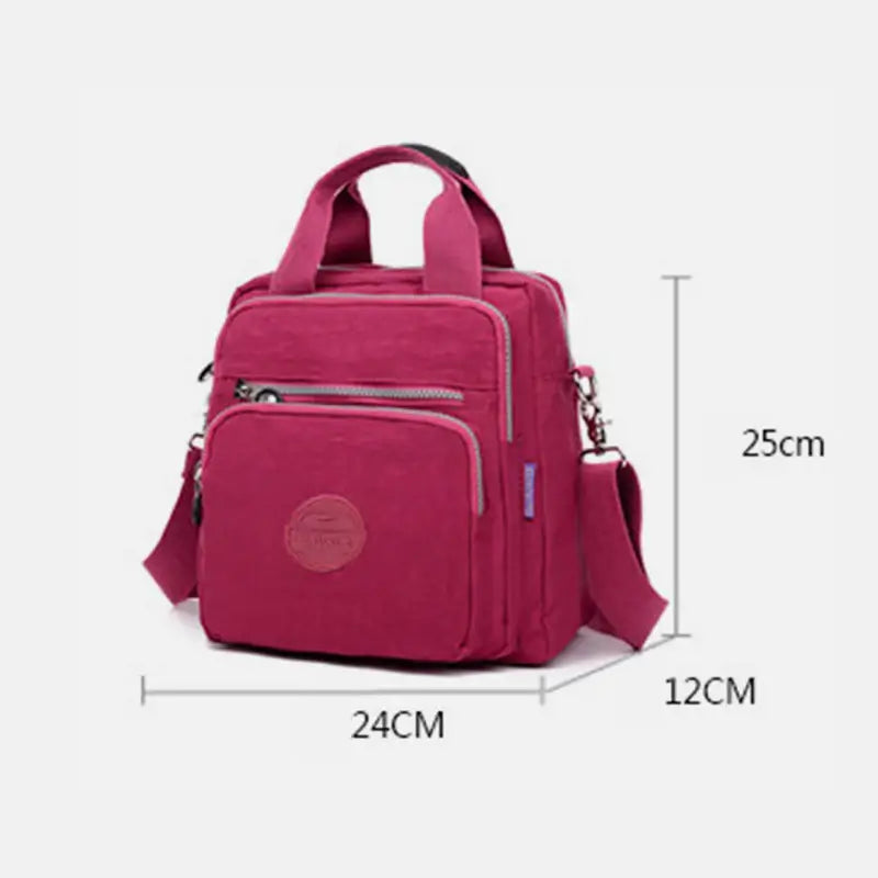 Sac à main rose en toile, dimensions 24x12x25 cm, avec bandoulière réglable et poches zippées. Accessoire mode femme, pratique et tendance.