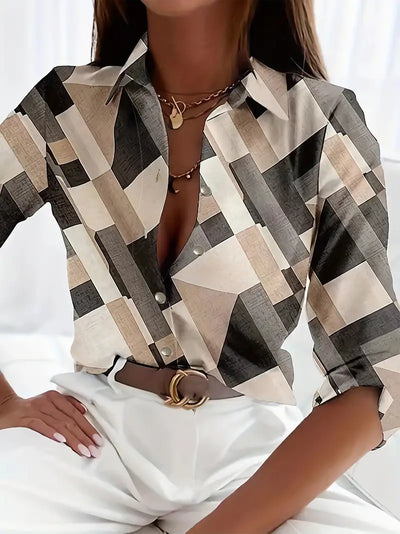 Chemisier à motifs géométriques beige et noir, manches longues, porté avec un pantalon blanc. Style chic et moderne pour femme.