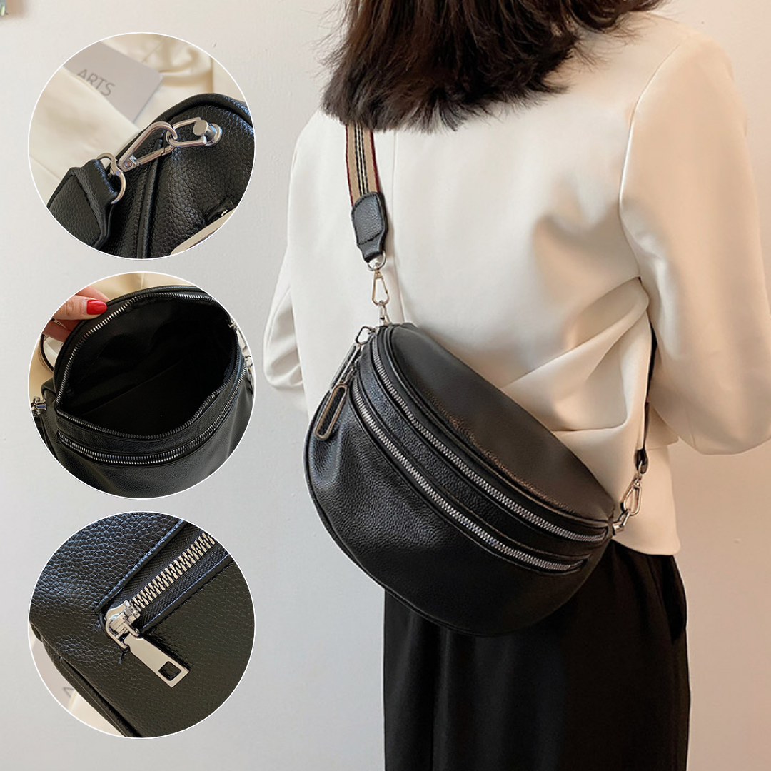 Sac banane en cuir noir porté par une femme, avec bandoulière réglable. Détails des fermetures éclair et compartiments intérieurs visibles. Accessoire mode tendance.