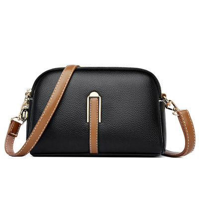 Sac à bandoulière en cuir noir élégant avec sangle marron, design moderne, idéal pour femme, accessoire mode tendance, fermeture éclair dorée.