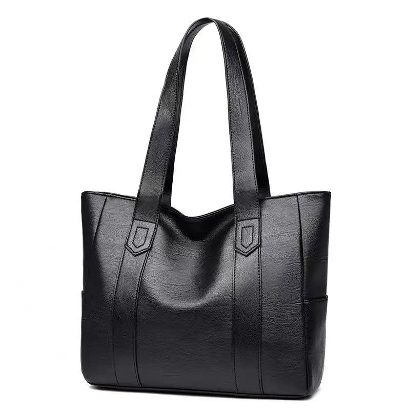 Sac à main en cuir noir élégant avec anses longues, design moderne et spacieux, parfait pour le quotidien ou le bureau. Accessoire mode femme.