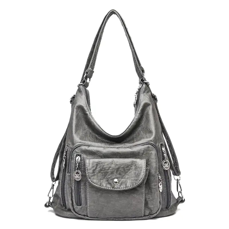 Sac à main en cuir gris avec bandoulière, poches zippées et bouton-pression. Élégant et pratique pour femme, idéal pour un usage quotidien.