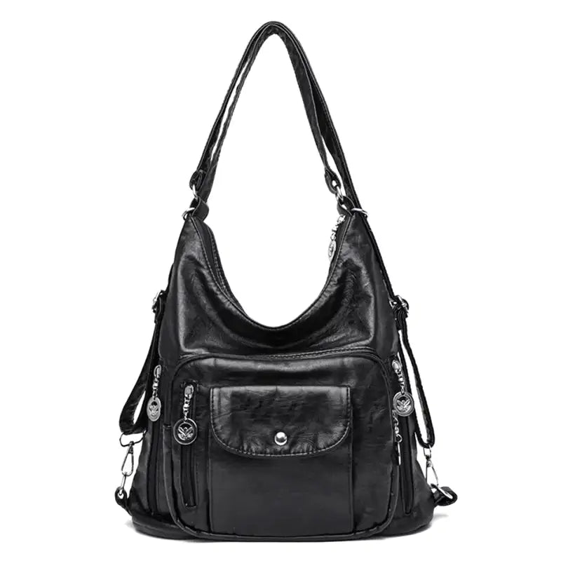Sac à main en cuir noir élégant avec bandoulière, poches zippées et détails métalliques. Accessoire mode femme chic et pratique.