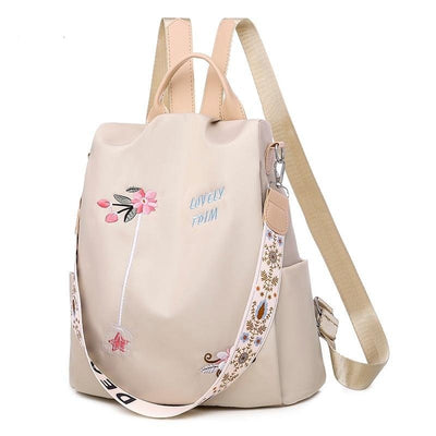 Sac à dos beige élégant avec broderie florale rose, sangle décorative, et inscription "Lovely Form". Accessoire mode tendance pour femmes.