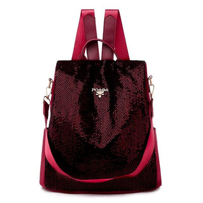 Sac à dos en cuir rouge bordeaux brillant avec paillettes, bretelles ajustables, design élégant et moderne, idéal pour la mode féminine.